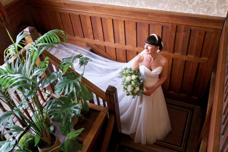 The bride on the oak-panelled settle with her bouquet, The Montagu Arms Hotel