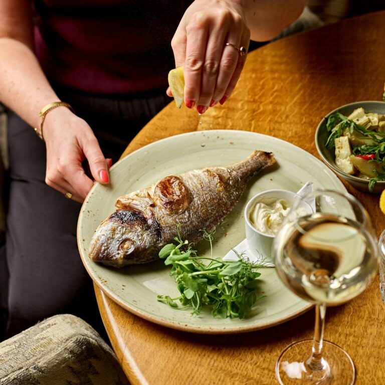 Whole roasted sea bass with a glass of white wine, The Montagu Arms Hotel