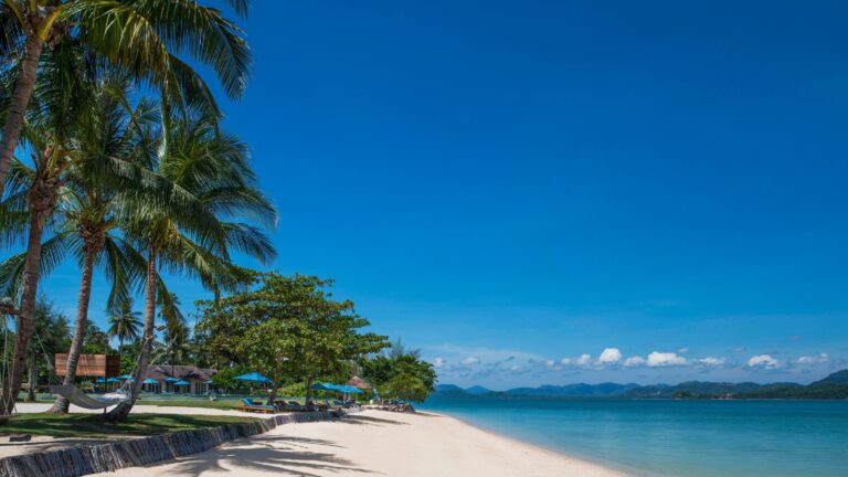 The resort beachfront with sun loungers, The Naka Island, A Luxury Collection Resort and Spa, Phuket