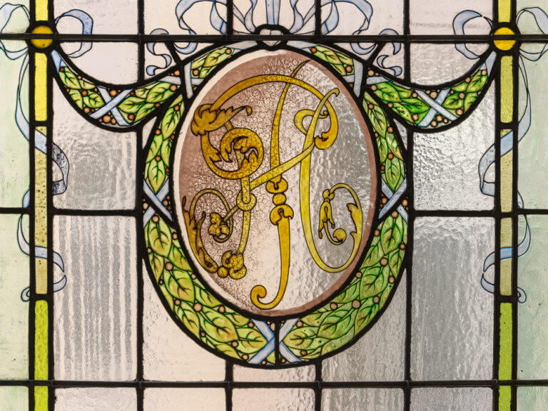 A stained glass panel bearing the hotel monogram, The Palace, a Luxury Collection Hotel, Madrid