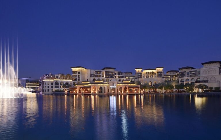 The hotel on the edge of Burj Lake at night, with the Dubai Fountain in play, The Palace Downtown Dubai