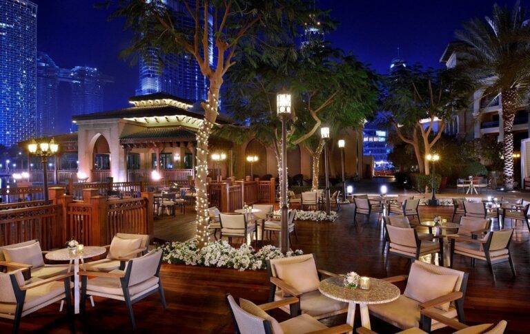 Buhayra Lounge by the pool, lit at night, The Palace Downtown Dubai