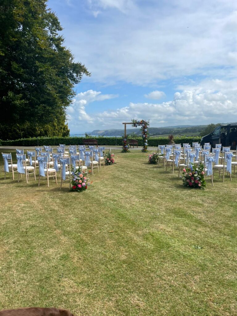 Chairs set out for a ceremony on the lawn, The Penrallt Country House Hotel