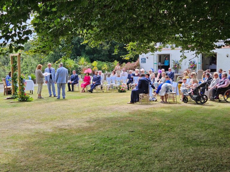 A wedding ceremony on the lawn, The Penrallt Country House Hotel