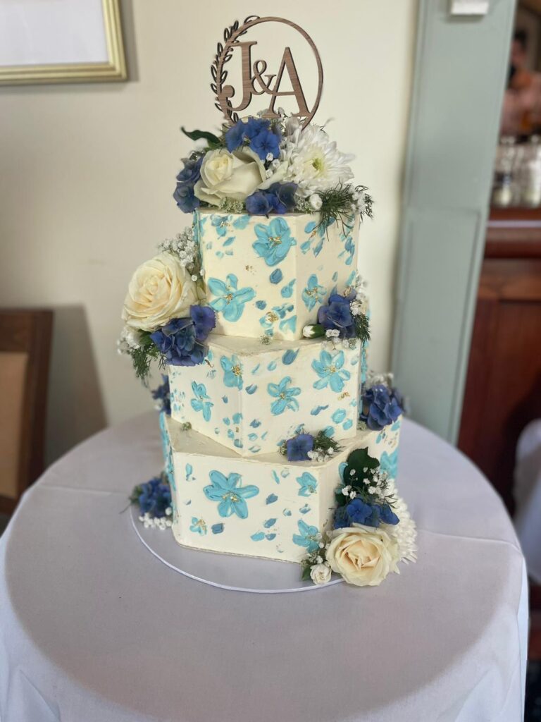 A wedding cake with blue floral decoration, The Penrallt Country House Hotel