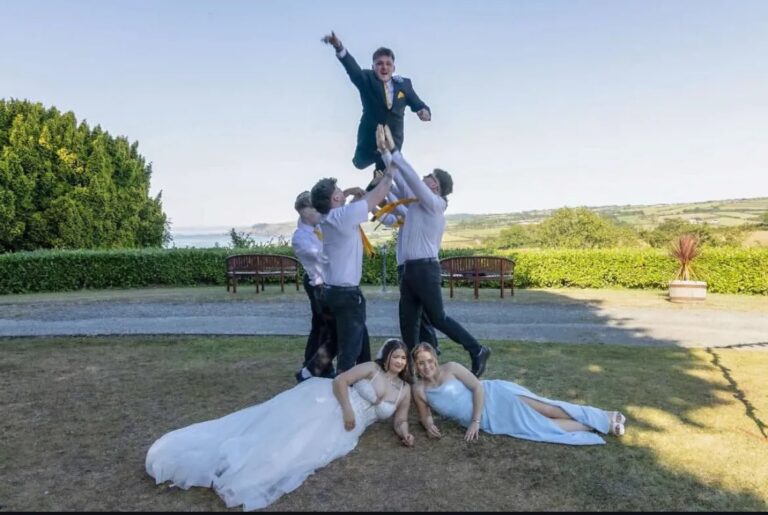 A wedding party with the coast behind, The Penrallt Country House Hotel