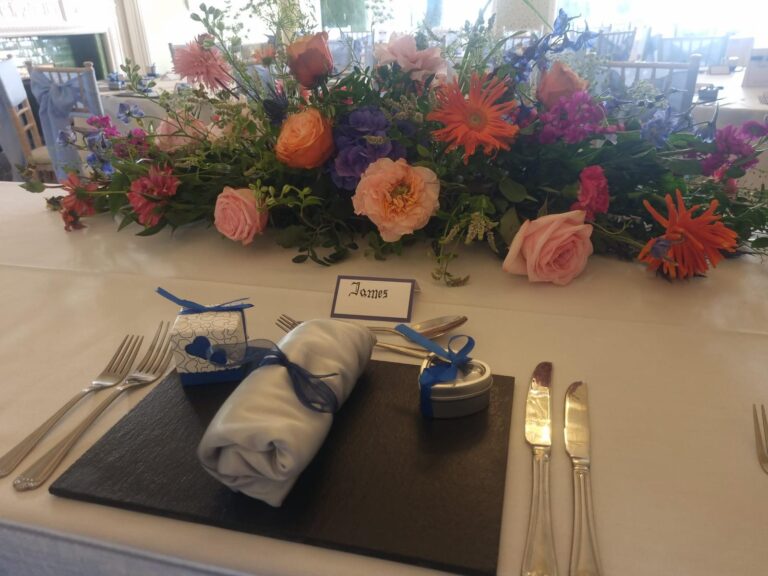 Table flowers and a place setting, The Penrallt Country House Hotel