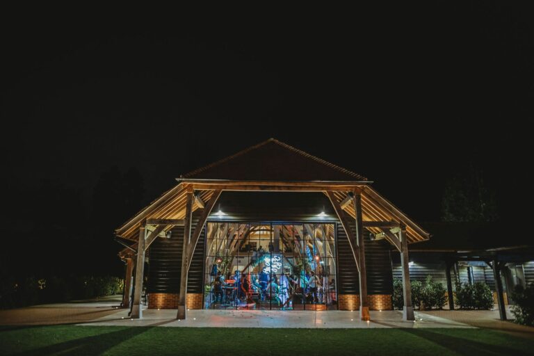 The barn at night with the evening party visible through the glass end wall, The Post Barn