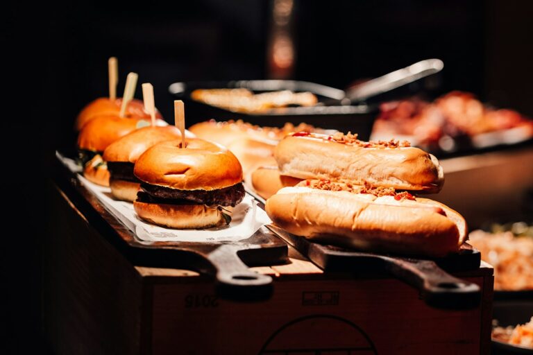 Burgers and hot dogs on boards at a street-food station, The Post Barn