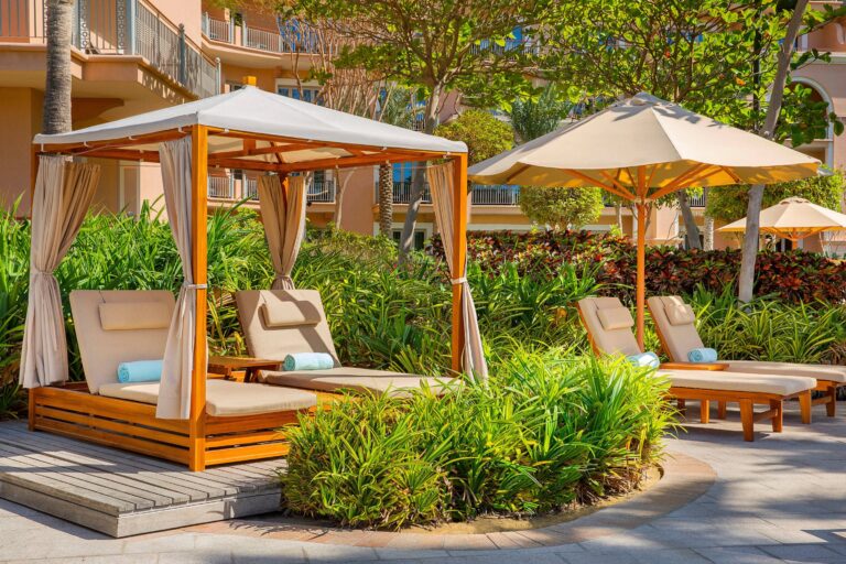 Poolside cabanas in the landscaped gardens, The Ritz-Carlton, Dubai