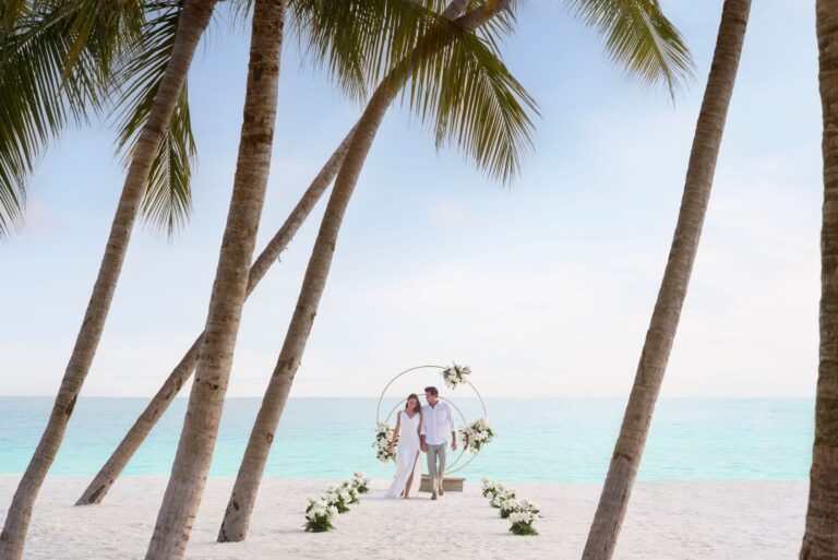 Beach ceremony arch set between palms, The Ritz-Carlton Maldives, Fari Islands