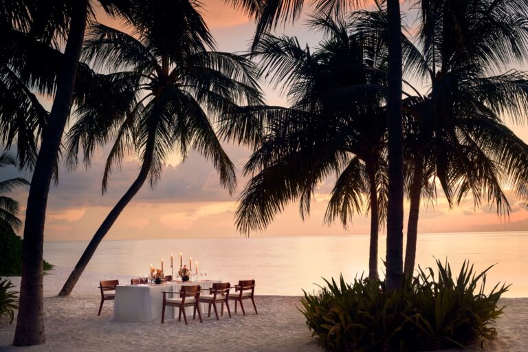 Beach dinner table among palms, The Ritz-Carlton Maldives, Fari Islands