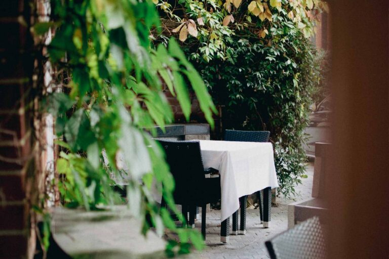A table laid in the Secret Garden, the walled terrace off the restaurant, The Roseate Reading