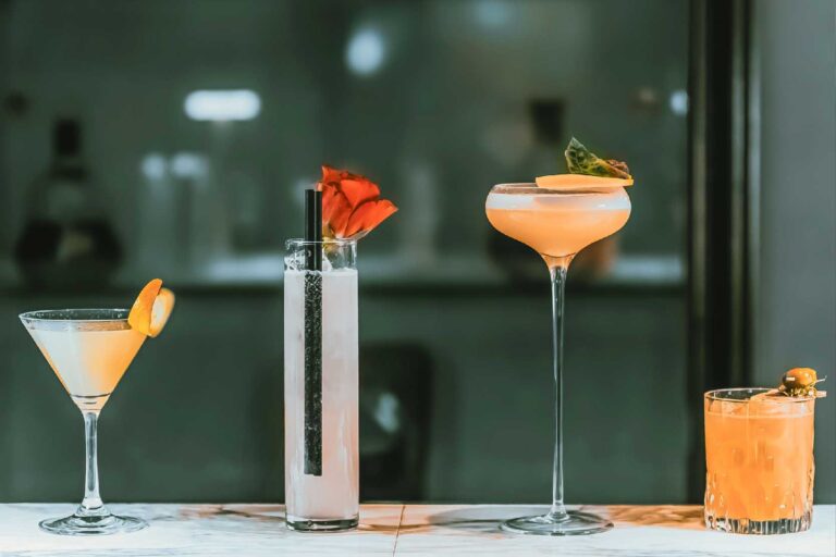 Four cocktails lined up on the bar counter at The Reading Room, The Roseate Reading