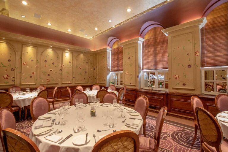 Round tables laid for a wedding breakfast in the Eden Room, the former county council chamber, The Roseate Reading