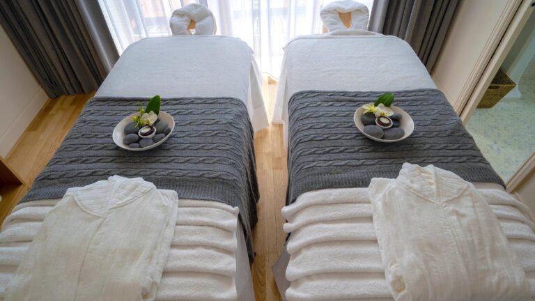 A twin treatment room at the rooftop Aheli Spa, laid with robes and towels, The Roseate Reading
