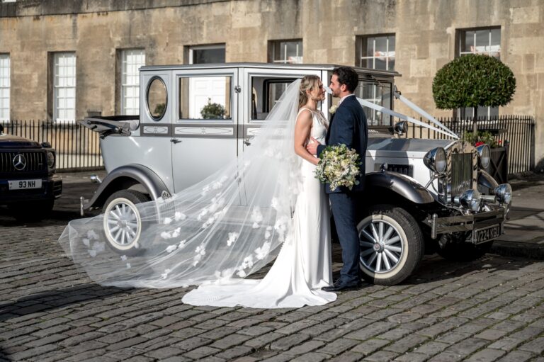 A couple beside a vintage wedding car in front of the hotel, The Royal Crescent Hotel & Spa