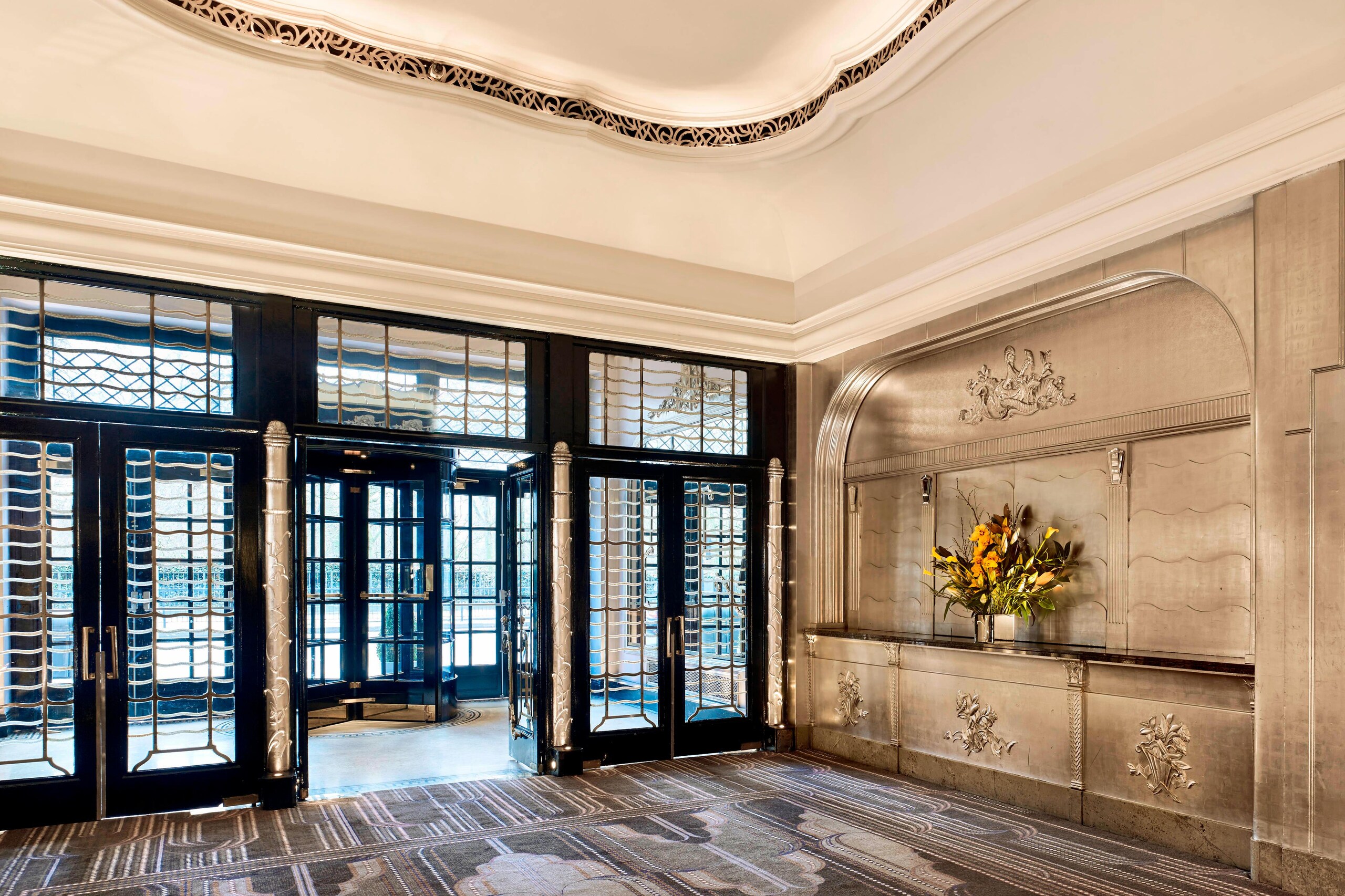 The Art Deco foyer inside the Ballroom entrance, with silvered relief panels and leaded glass doors, The Sheraton Park Lane Hotel
