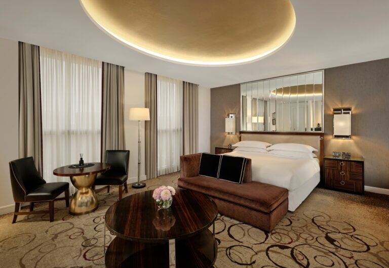 The Grand Park View Suite bedroom with a mirrored wall, a velvet day bed and a gilded ceiling dome, The Sheraton Park Lane Hotel