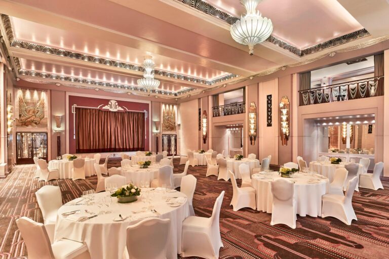 Round tables in the Ballroom seen from the corner, with the balcony and the stage behind, The Sheraton Park Lane Hotel