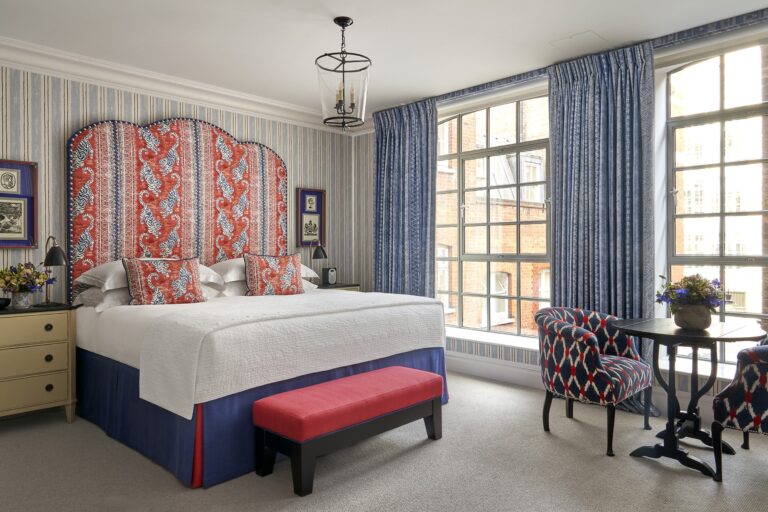 A bedroom with a tall headboard and warehouse windows, The Soho Hotel