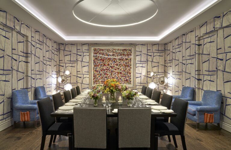 A long dinner table in the Sandra Blow Room, The Soho Hotel