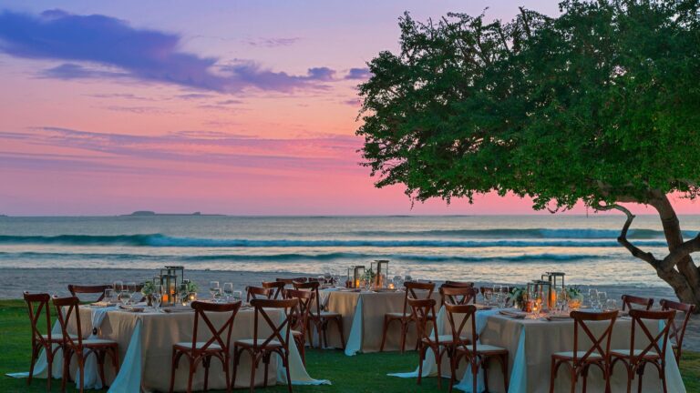 Round tables set for a reception on the lawn at sunset, The St. Regis Punta Mita Resort