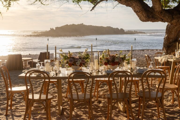 A banquet table on the sand with the islands behind, The St. Regis Punta Mita Resort