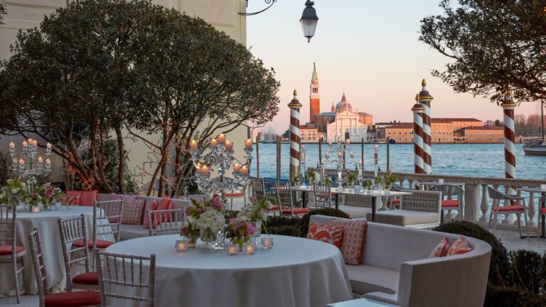 Round tables in the Italianate Garden at dusk, The St. Regis Venice