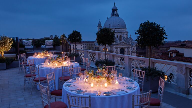 Round tables on the Santa Maria Suite terrace at dusk, The St. Regis Venice
