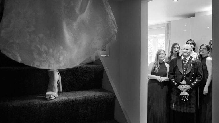 The dress on the stairs, the wedding party waiting below, The Studio Without Walls