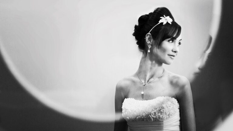 The bride, glancing back, through a round window, The Studio Without Walls