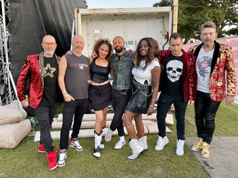 The band lined up in front of a stage, The Sway Allstars