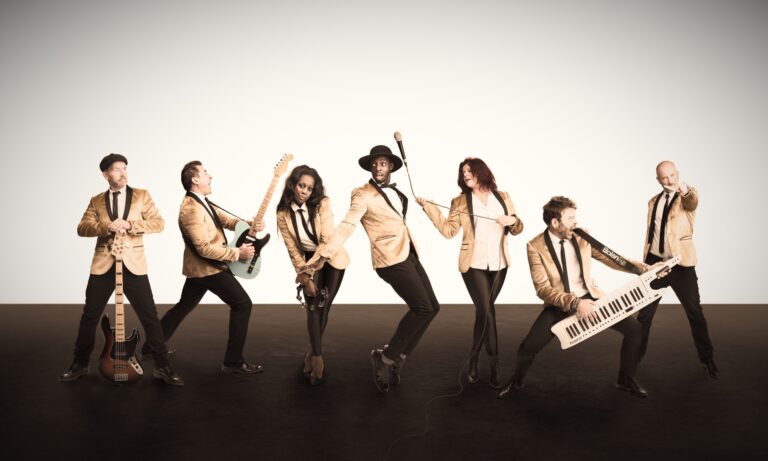 Seven band members in a studio promotional photograph, The Sway Allstars