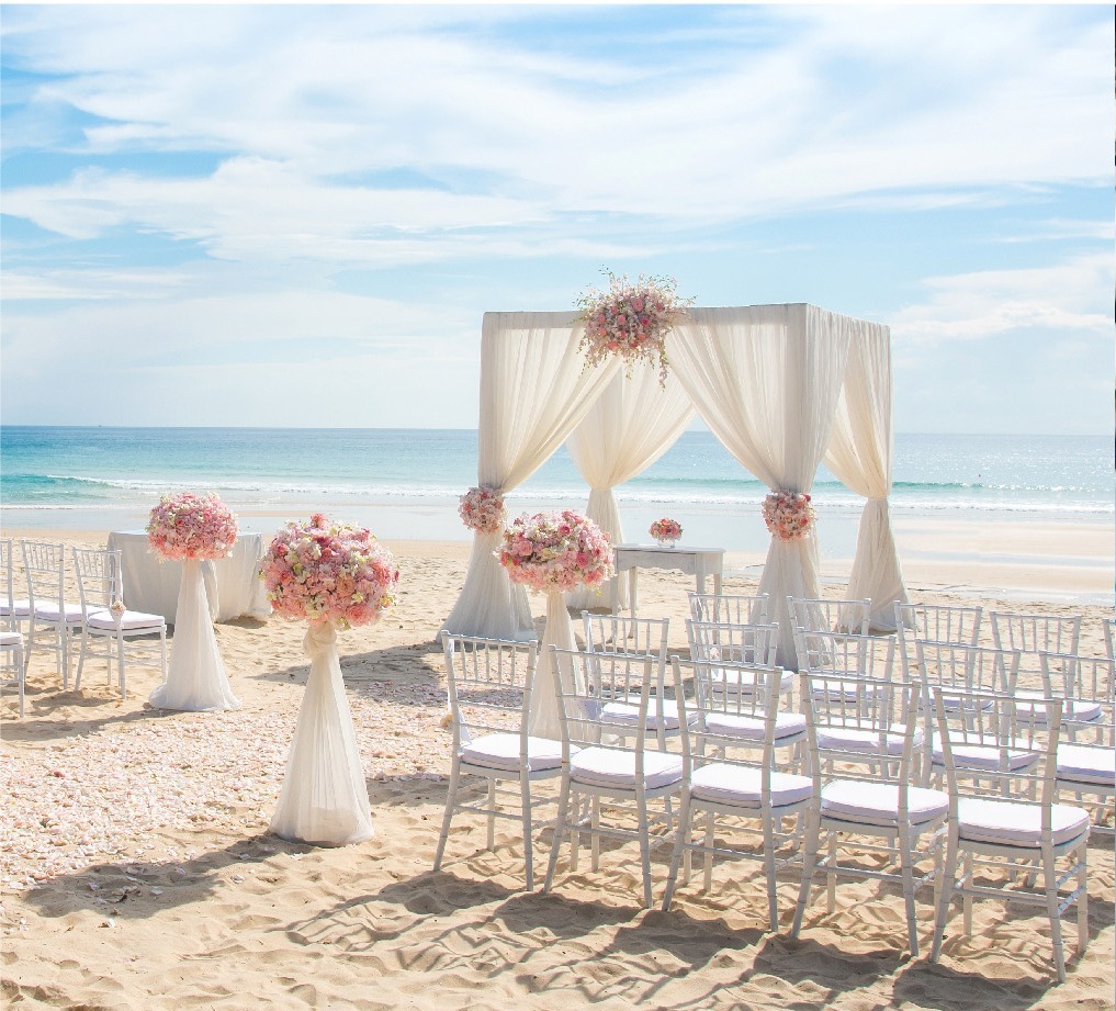 Beach ceremony setting with white arch and chiavari chairs, The Taaras Beach and Spa Resort