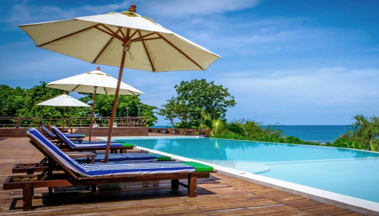 Pool deck with sun loungers and umbrellas overlooking the sea, The Treasure Resort Koh Madsum - Samui