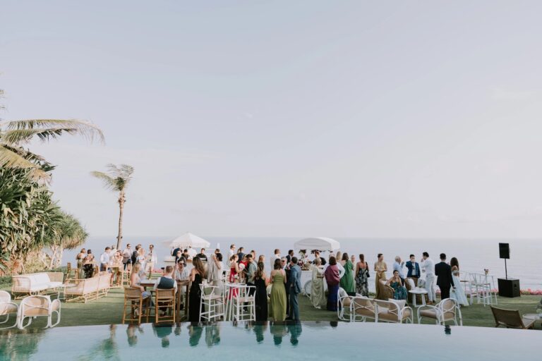 Guests at a reception on the lawn beside the pool, The Ungasan Clifftop Resort
