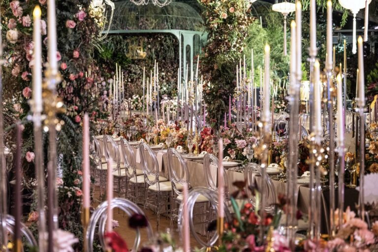 A candlelit banquet table inside a floral marquee, The Vanderbilt Estate