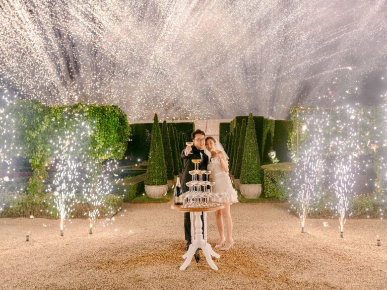 A couple with a champagne tower and fireworks in the garden, The Vanderbilt Estate