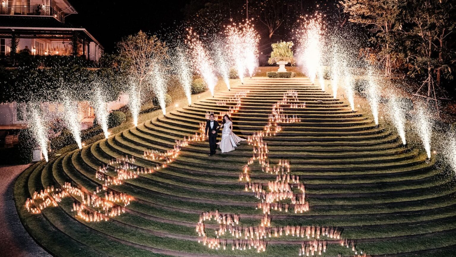 Candlelight and fireworks on the terraced lawn steps during a wedding