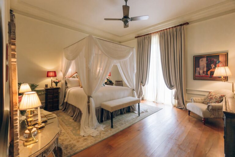 Upper floor bedroom with a draped canopy bed, The Vanderbilt Estate