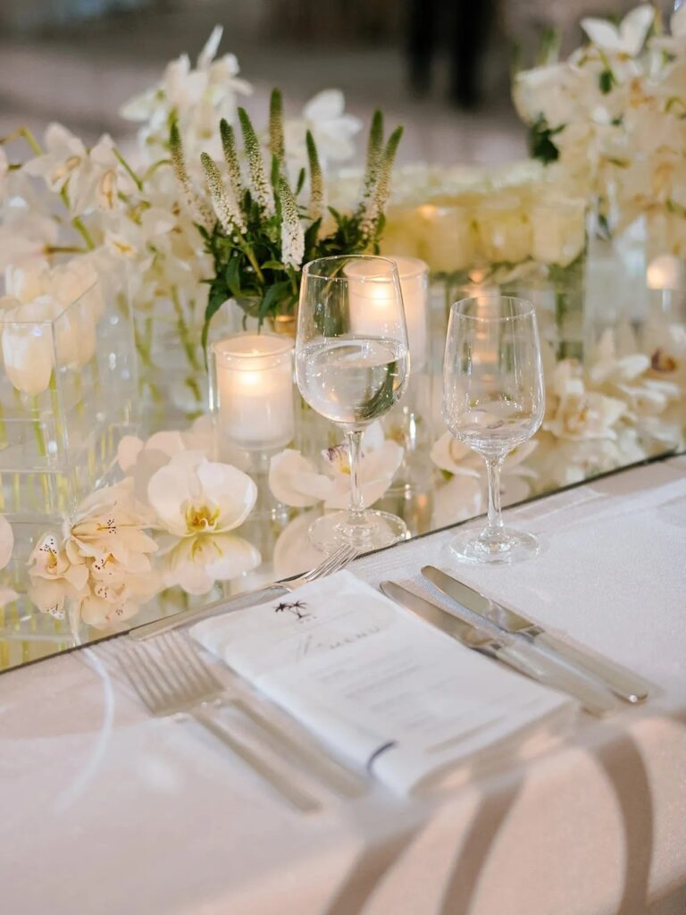 A wedding tablescape with white flowers and candles, The Wedding Atelier