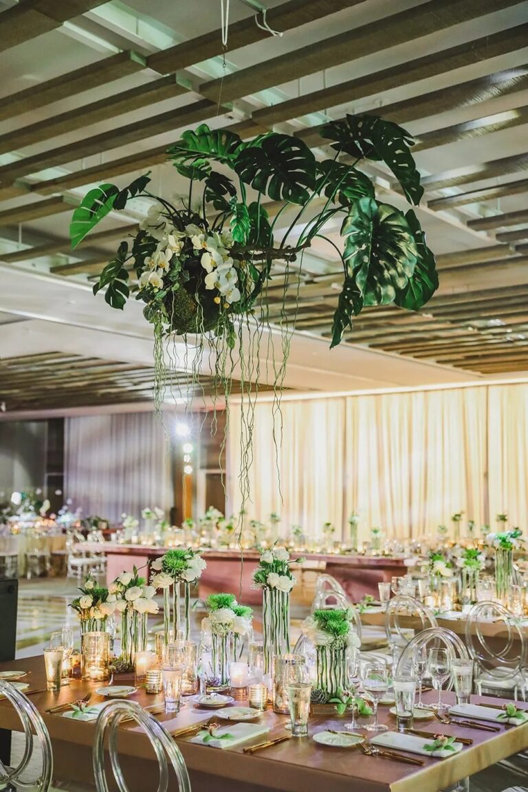 A reception with hanging greenery over tables, The Wedding Atelier