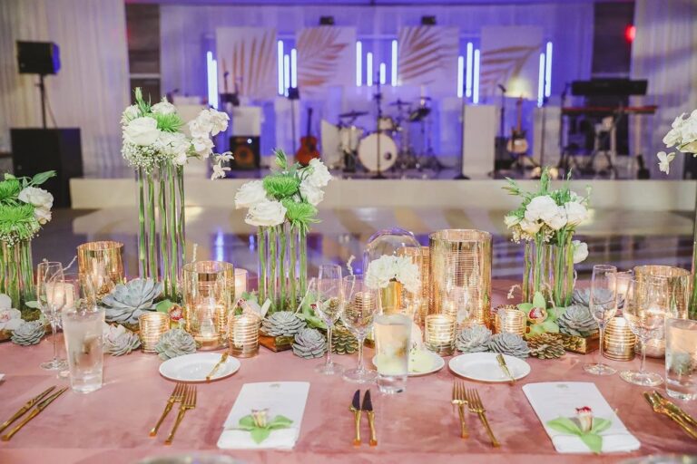 A reception hall lit in pink and purple, The Wedding Atelier