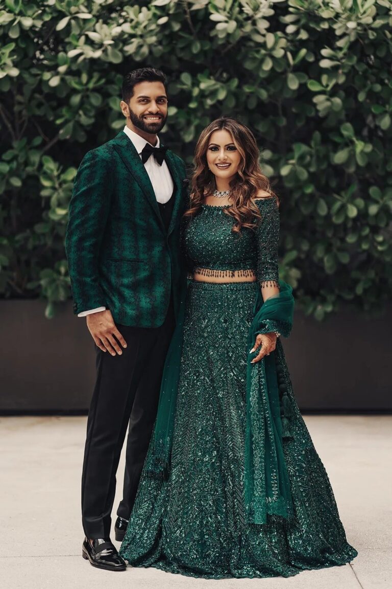 A couple in green outfits in a garden, The Wedding Atelier