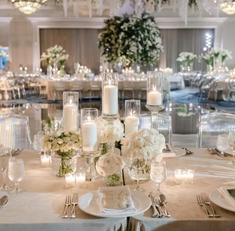 A reception table with tall floral centrepieces, The Wedding Atelier