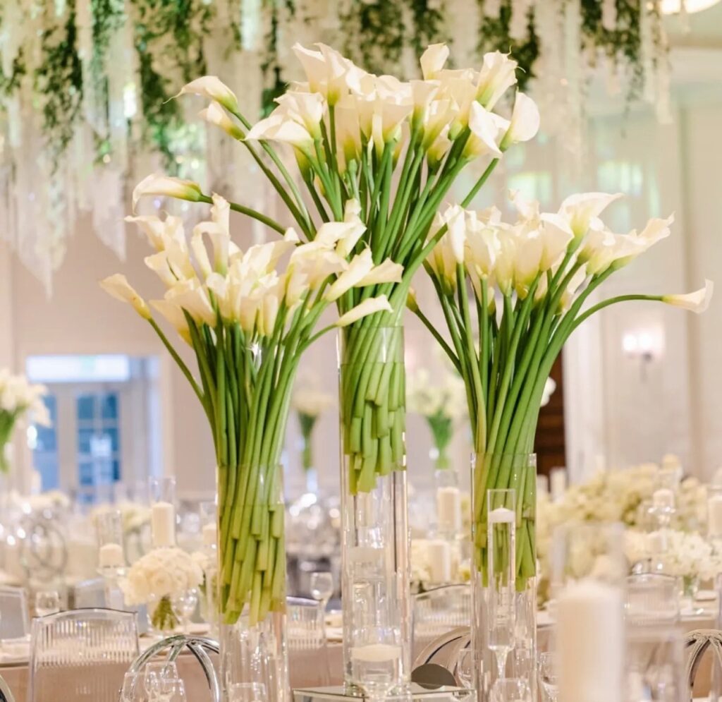 Tall white calla lilies as wedding table centrepieces, The Wedding Atelier