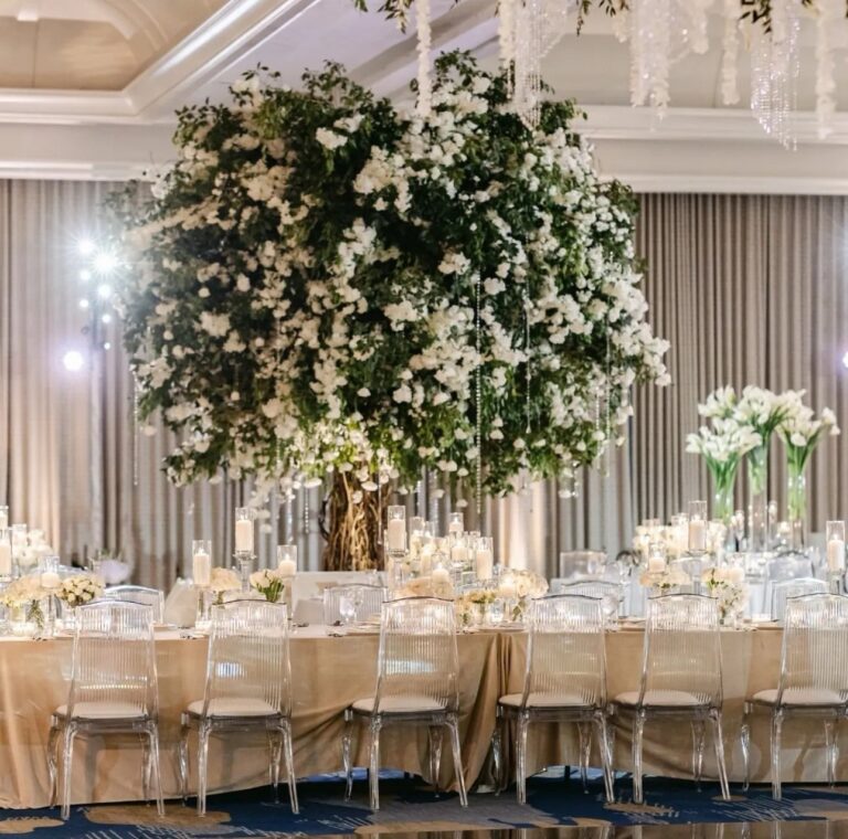 A round table with a tall floral centrepiece, The Wedding Atelier