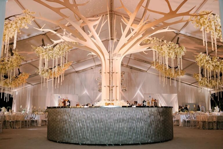 A reception hall with a feature tree installation, The Wedding Atelier