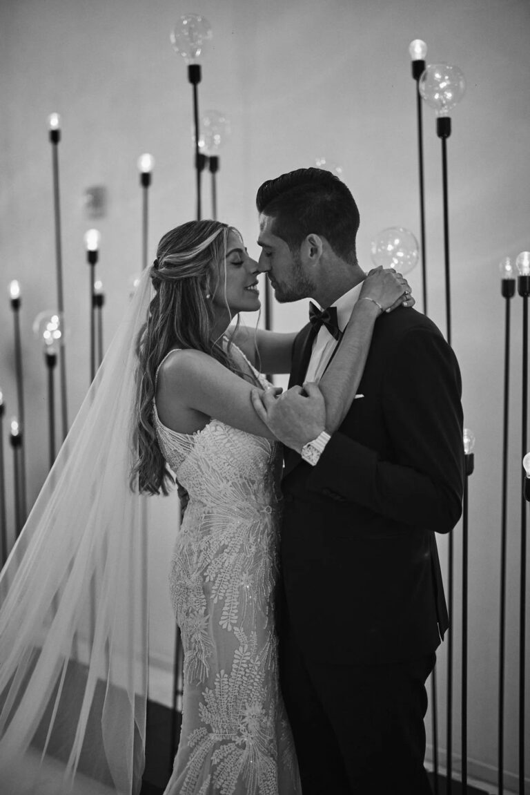 A couple kissing, in black and white, The Wedding Atelier